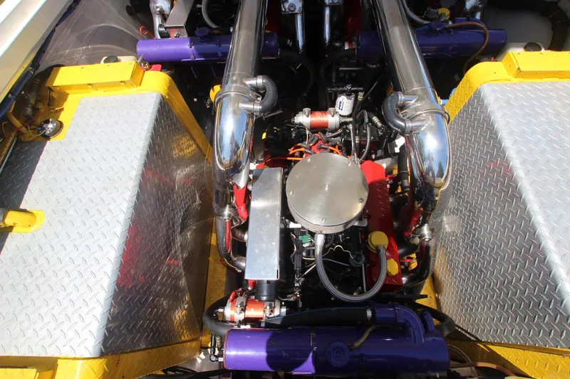  Yacht Photos Pics Engine compartment of a 2001 Cigarette 46 Rough Rider boat, featuring chrome and vibrant components.