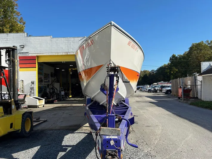  Yacht Photos Pics 2001 Cigarette 46 Rough Rider boat on trailer outside a garage.