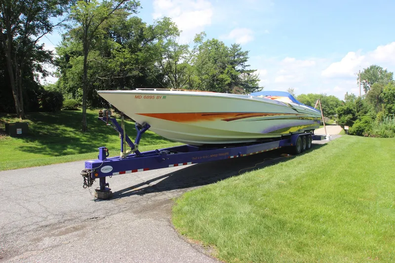  Yacht Photos Pics 2001 Cigarette 46 Rough Rider boat on trailer, parked on a sunny road.