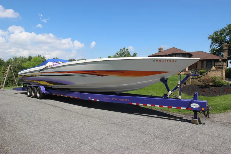  Yacht Photos Pics 2001 Cigarette 46 Rough Rider boat on a trailer, parked on a driveway.