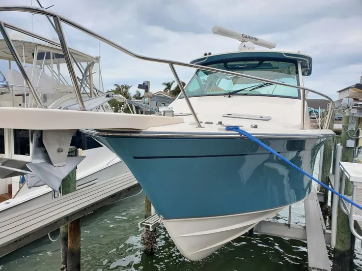 Rising Sun Yacht Photos Pics 2018 Grady-White Express 330 boat docked, featuring a sleek blue hull and modern design.