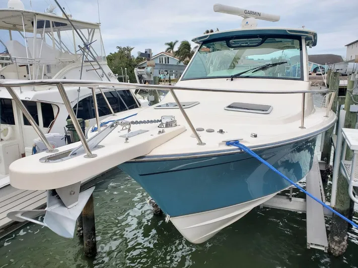 Rising Sun Yacht Photos Pics 2018 Grady-White Express 330 boat docked, featuring a sleek blue hull and modern design.