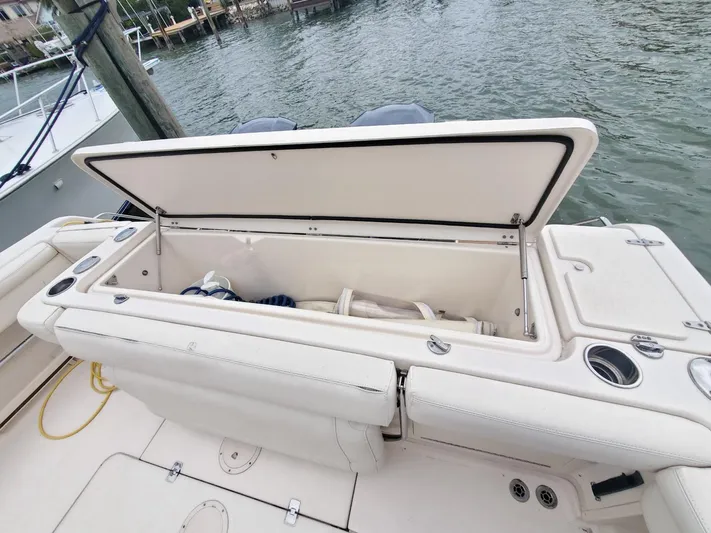 Rising Sun Yacht Photos Pics 2018 Grady-White Express 330 boat with open storage compartment by the water.