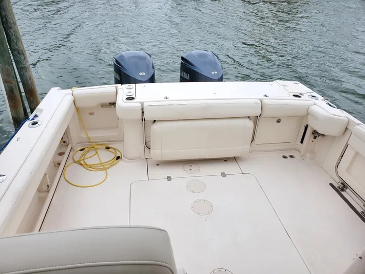 Rising Sun Yacht Photos Pics 2018 Grady-White Express 330 boat deck with twin Yamaha engines, docked by water.