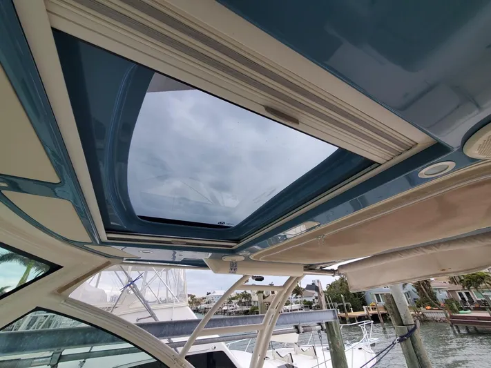 Rising Sun Yacht Photos Pics 2018 Grady-White Express 330 boat with open sunroof, docked at marina.