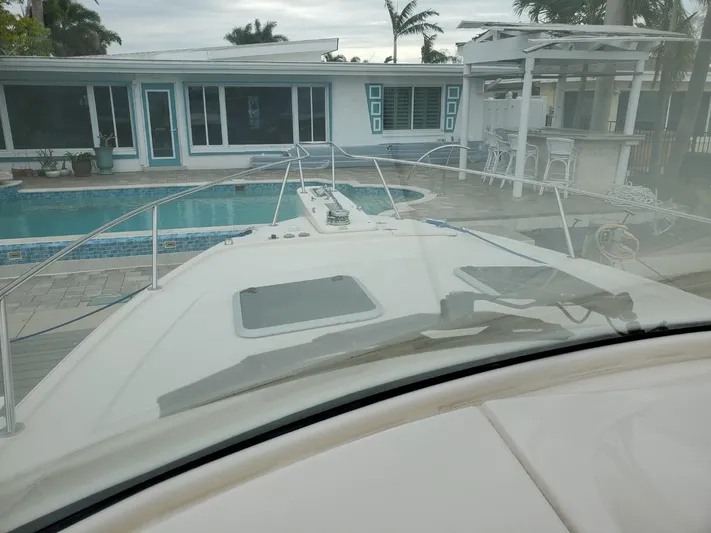 Rising Sun Yacht Photos Pics 2018 Grady-White Express 330 boat docked near a poolside patio.