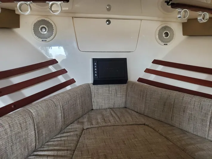 Rising Sun Yacht Photos Pics 2018 Grady-White Express 330 cabin interior with cushioned seating and built-in speakers.