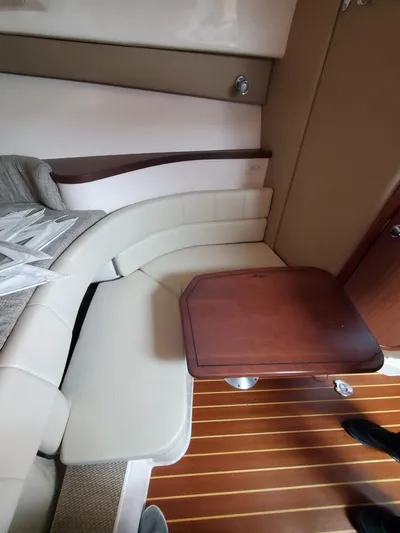 Rising Sun Yacht Photos Pics 2018 Grady-White Express 330 cabin interior with seating and wooden table.