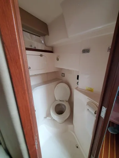Rising Sun Yacht Photos Pics 2018 Grady-White Express 330 boat bathroom interior with toilet and storage cabinets.