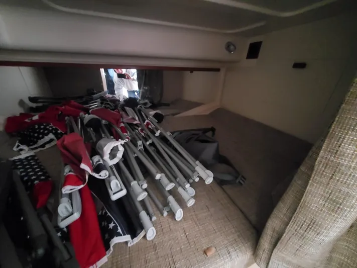Rising Sun Yacht Photos Pics Interior cabin of 2018 Grady-White Express 330 with folded chairs and flags.