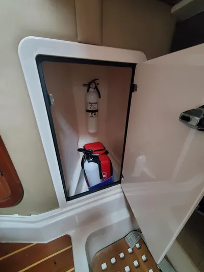 Rising Sun Yacht Photos Pics 2018 Grady-White Express 330 storage compartment with fire extinguisher and safety equipment.