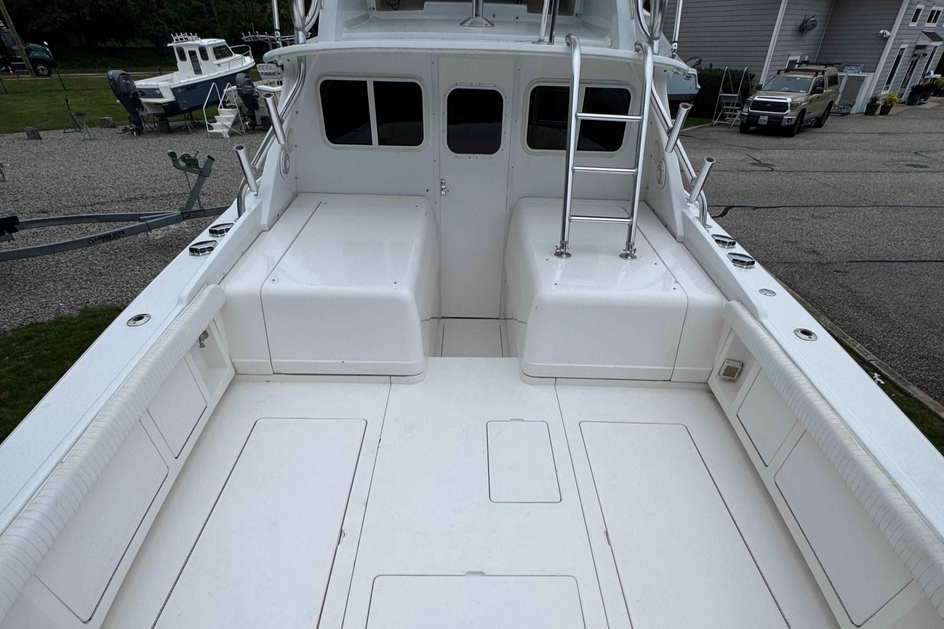 1964 Bertram 31 Flybridge Cruiser deck with ladder and seating area.