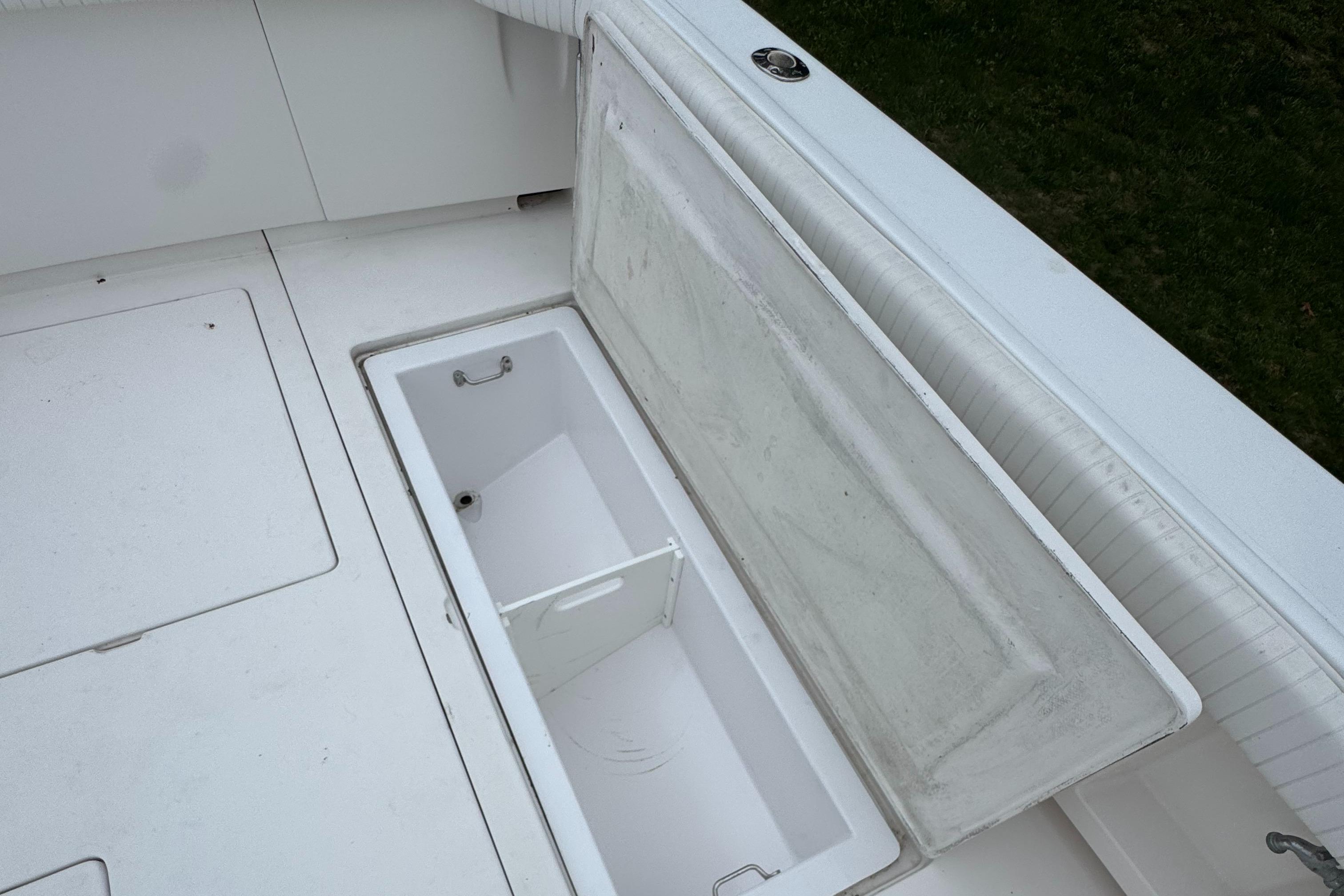 Open storage compartment on a 1964 Bertram 31 Flybridge Cruiser boat deck.