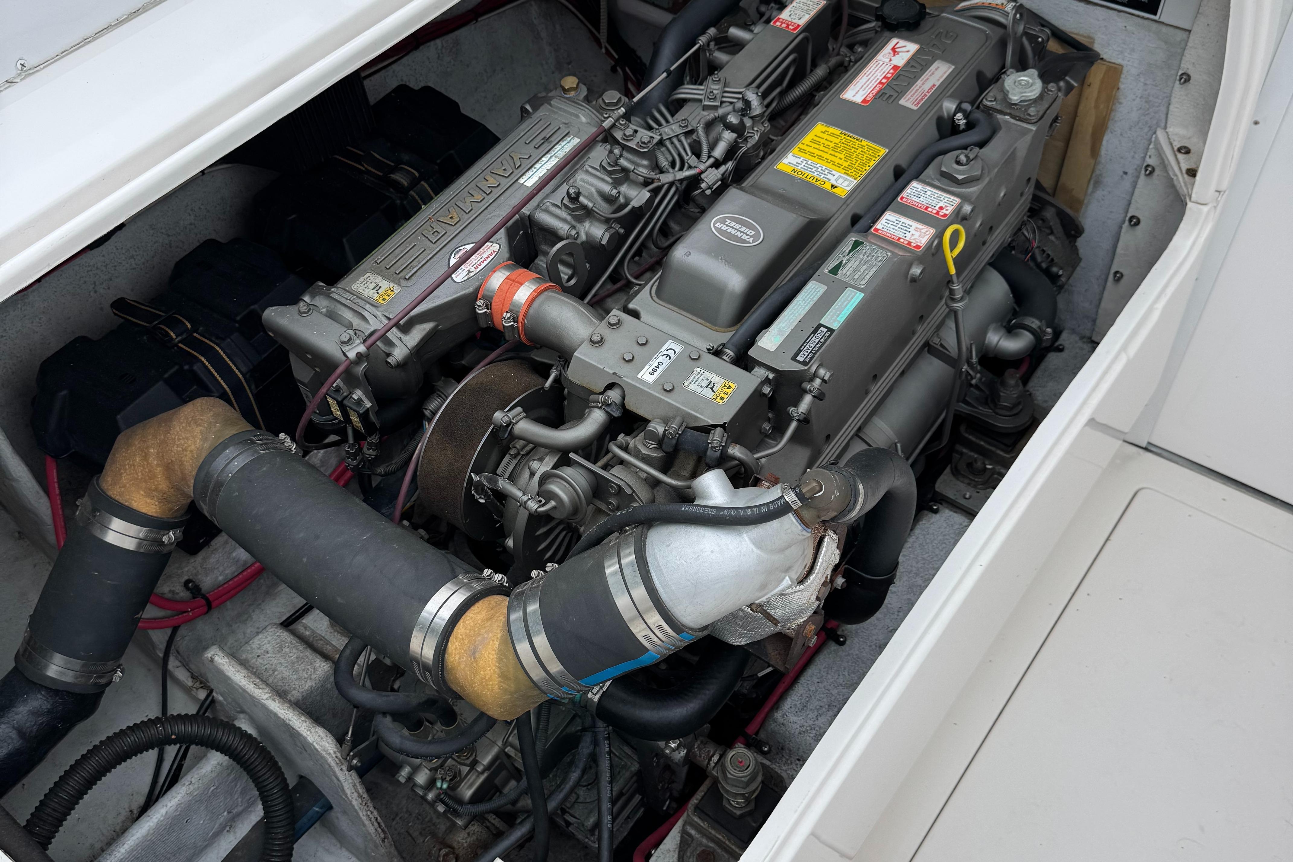 Engine compartment of a 1964 Bertram 31 Flybridge Cruiser, showcasing detailed mechanical components.