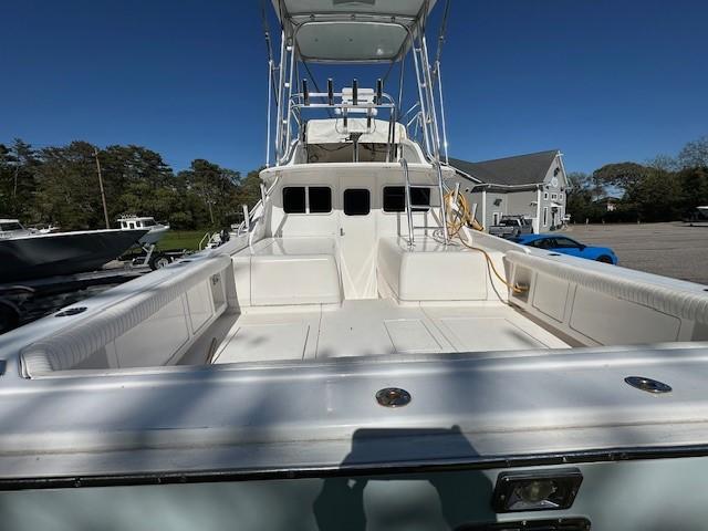 1964 Bertram 31 Flybridge Cruiser with spacious deck and seating, docked under clear skies.