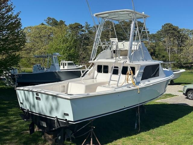 1964 Bertram 31 Flybridge Cruiser on display outdoors, showcasing classic design and structure.