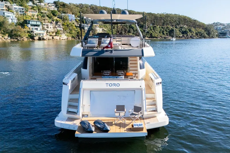 Toro Yacht Photos Pics Luxury 2017 Ferretti Yachts 850 on serene water, featuring spacious deck and modern design.