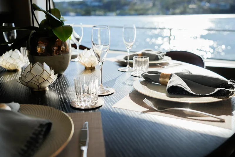 Toro Yacht Photos Pics Elegant dining setup on 2017 Ferretti Yachts 850, overlooking serene water views.