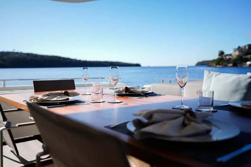 Toro Yacht Photos Pics Elegant dining setup on 2017 Ferretti Yachts 850, overlooking serene ocean view.