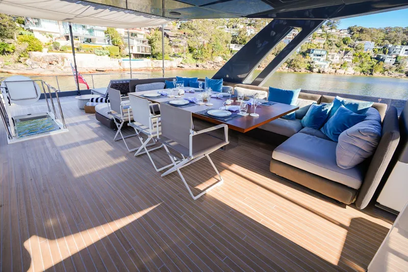 Toro Yacht Photos Pics Luxurious 2017 Ferretti Yachts 850 deck with elegant dining setup and scenic waterfront view.