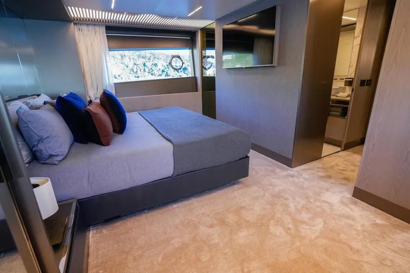 Toro Yacht Photos Pics Luxurious bedroom interior of 2017 Ferretti Yachts 850 with modern decor and large window.
