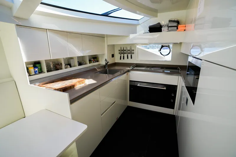 Toro Yacht Photos Pics Modern kitchen interior of 2017 Ferretti Yachts 850, featuring sleek cabinetry and appliances.