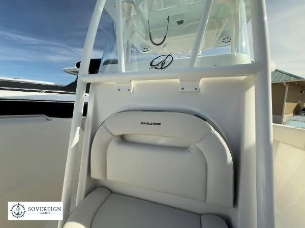  Yacht Photos Pics 2024 Sailfish 242 CC boat interior with white seating and console, Sovereign Yachts logo visible.