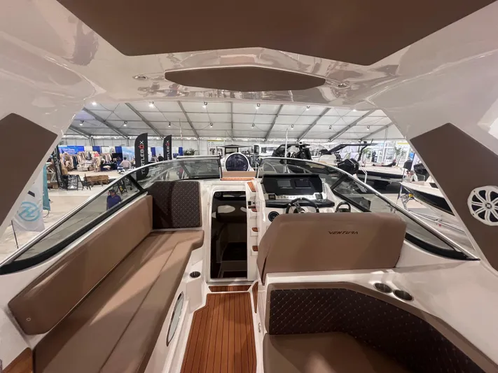  Yacht Photos Pics 2025 Ventura DayCruiser interior with modern seating and dashboard at a boat show.
