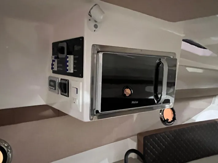  Yacht Photos Pics Interior of 2025 Ventura DayCruiser featuring a modern microwave and control panel.