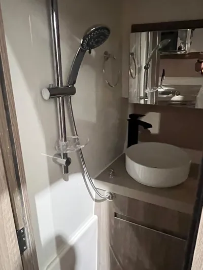  Yacht Photos Pics Compact bathroom in 2025 Ventura DayCruiser with modern shower and sink design.