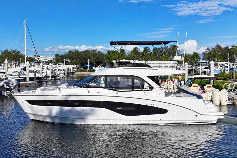  Yacht Photos Pics 2026 Beneteau Antares 12 yacht docked in a marina under a clear blue sky.