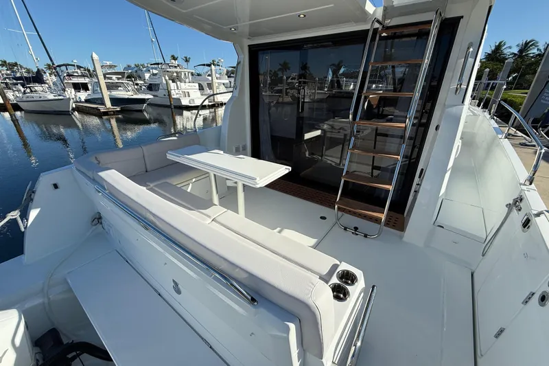  Yacht Photos Pics 2026 Beneteau Antares 12 yacht with outdoor seating and marina view.