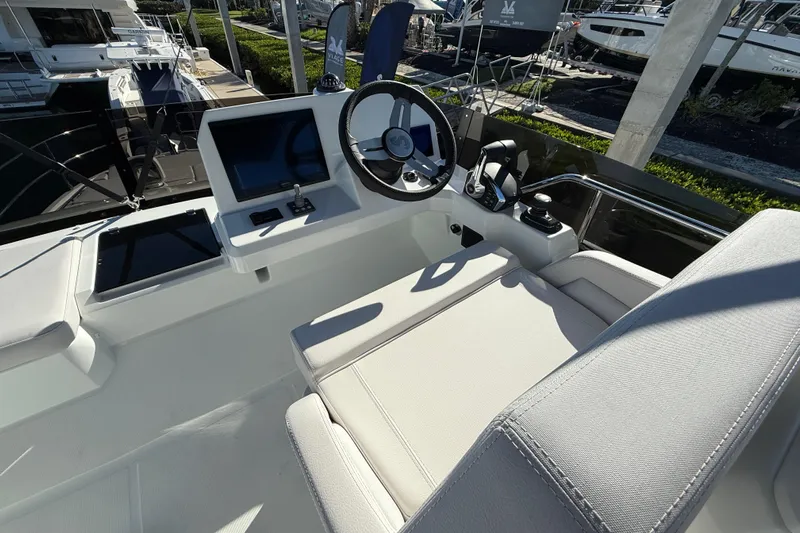  Yacht Photos Pics 2026 Beneteau Antares 12 helm station with modern controls and comfortable seating.