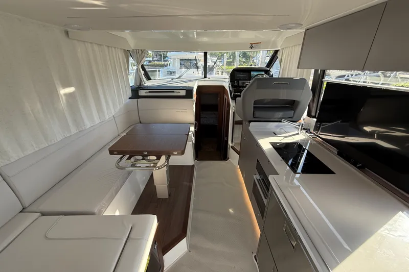  Yacht Photos Pics Interior of 2026 Beneteau Antares 12 yacht, featuring modern kitchen and seating area.