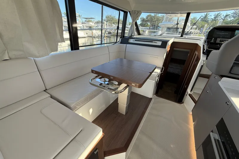 Yacht Photos Pics Interior of 2026 Beneteau Antares 12 yacht with modern seating and table.