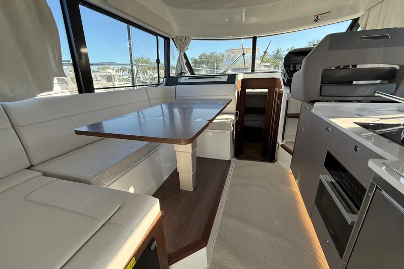  Yacht Photos Pics Interior of 2026 Beneteau Antares 12 yacht with modern seating and kitchen area.