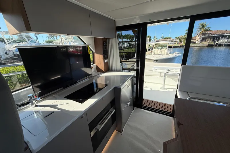  Yacht Photos Pics Interior of 2026 Beneteau Antares 12 yacht with modern kitchen and waterfront view.