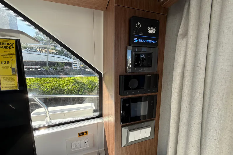  Yacht Photos Pics Control panel inside 2026 Beneteau Antares 12 yacht, featuring Seakeeper system and energy guide.