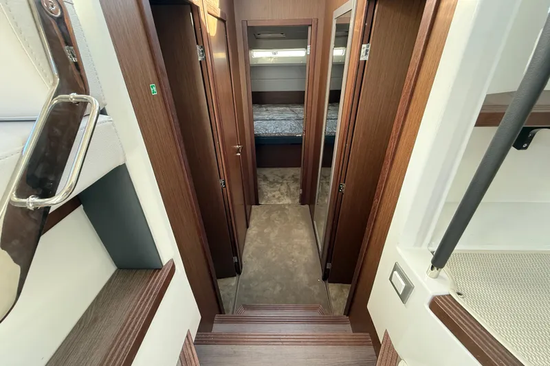  Yacht Photos Pics Interior of 2026 Beneteau Antares 12, featuring wood finishes and cozy cabin layout.