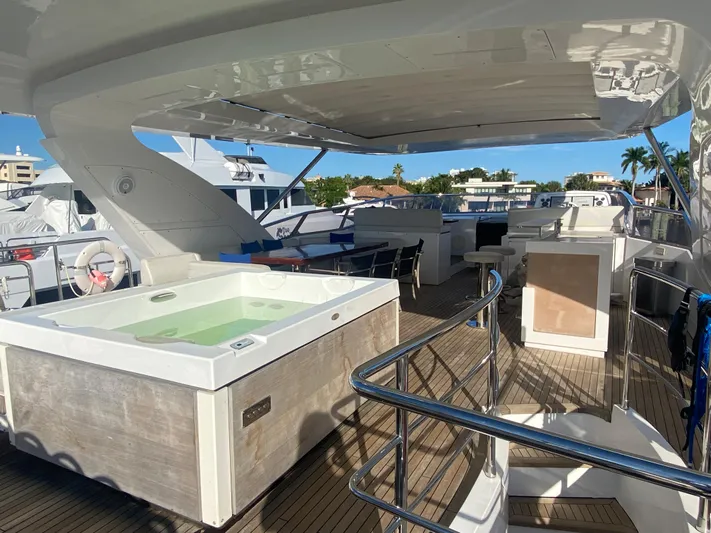 La Tache Yacht Photos Pics Luxurious deck of 2014 Azimut 100 Grande yacht with hot tub and seating area.