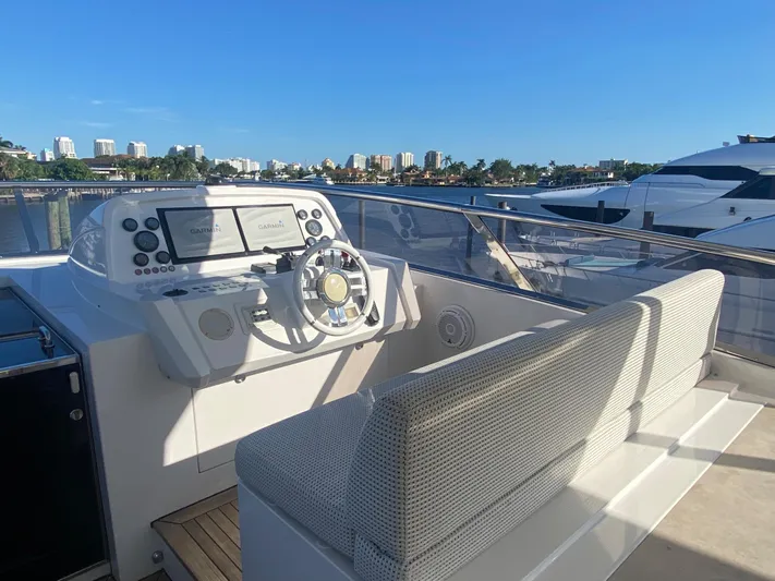 La Tache Yacht Photos Pics Helm station of 2014 Azimut 100 Grande yacht with city skyline in background.