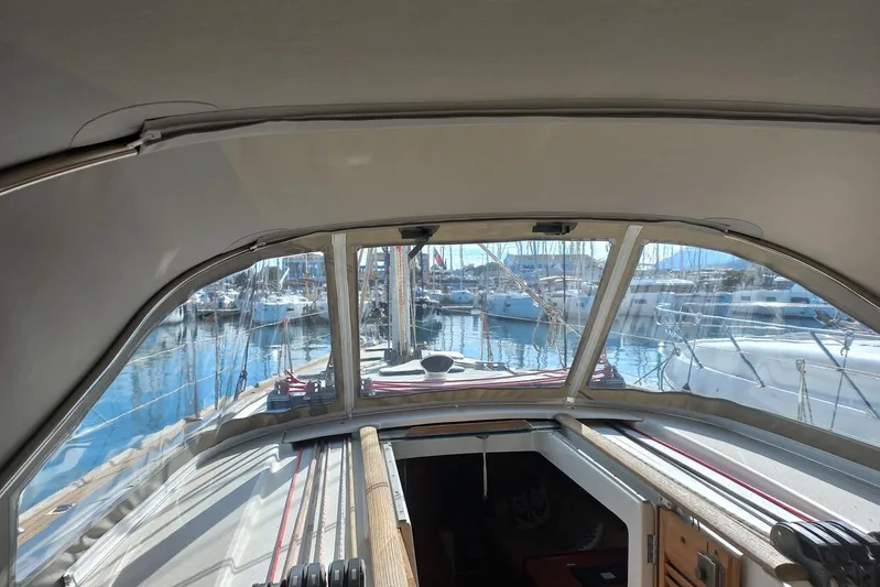 Yacht Photos Pics Interior view of a 2007 Beneteau 46 sailboat cockpit with marina backdrop.