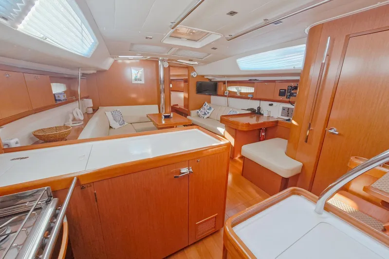  Yacht Photos Pics Luxurious interior of 2007 Beneteau 46 yacht with modern amenities and wooden finishes.