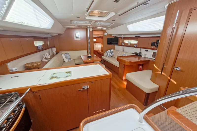  Yacht Photos Pics Luxurious interior of 2007 Beneteau 46 yacht with wood finish and comfortable seating.