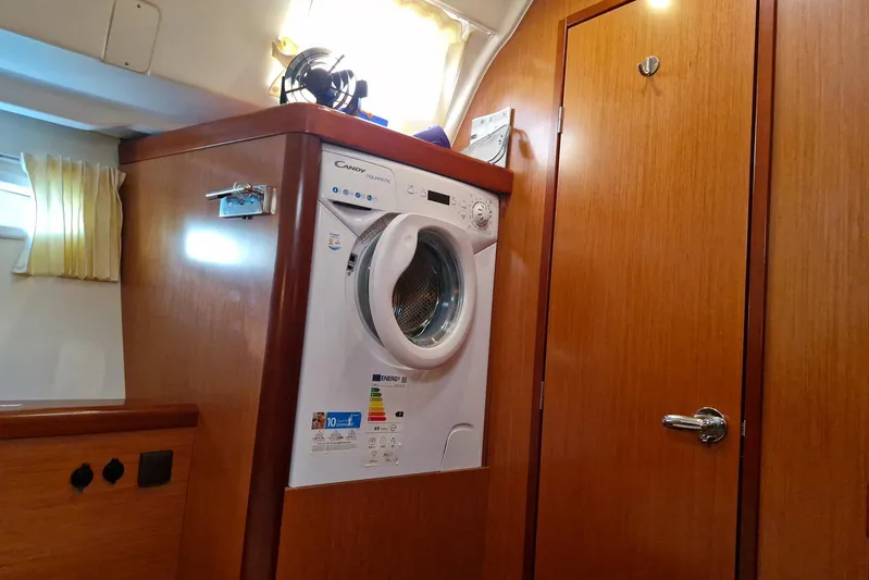  Yacht Photos Pics Laundry area inside a 2007 Beneteau 46 yacht, featuring a Candy washing machine.