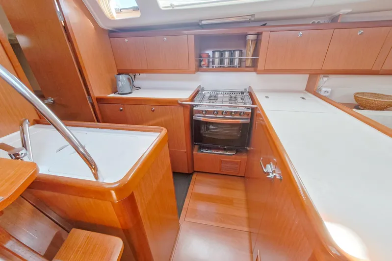  Yacht Photos Pics Luxurious 2007 Beneteau 46 yacht kitchen with wood cabinetry and modern appliances.