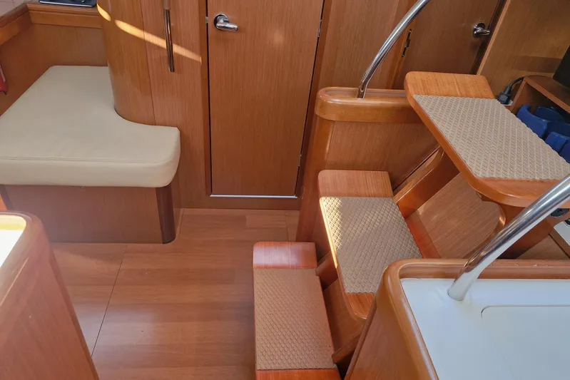  Yacht Photos Pics Interior of 2007 Beneteau 46 yacht with wooden stairs and seating area.