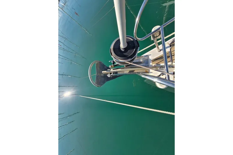  Yacht Photos Pics Bow view of 2007 Beneteau 46 sailboat with clear water reflection.