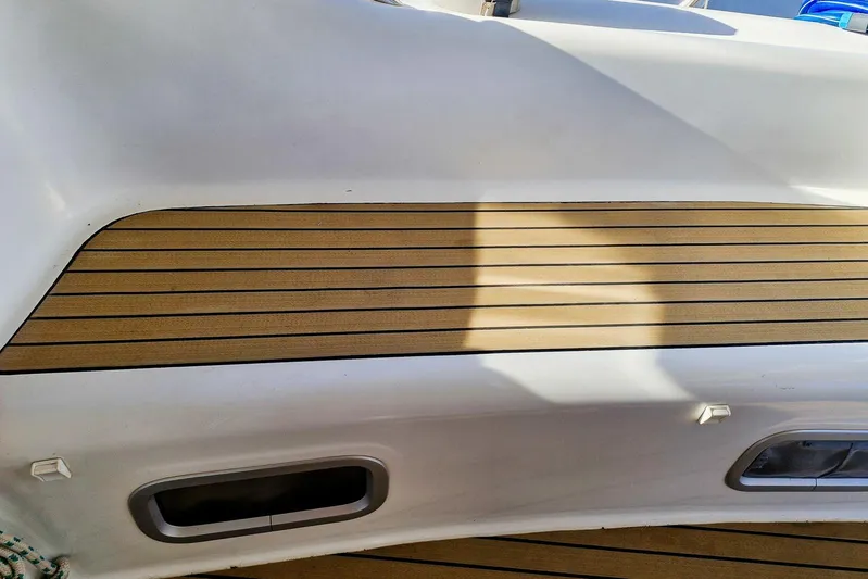  Yacht Photos Pics Teak deck of a 2007 Beneteau 46 sailboat, showcasing sleek design and craftsmanship.