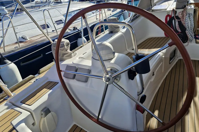  Yacht Photos Pics 2007 Beneteau 46 yacht cockpit with wooden steering wheel and sleek design.